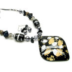 Elegant in black and gold with a silver shine, 20 inch necklace with 3 inch drop and earring to match